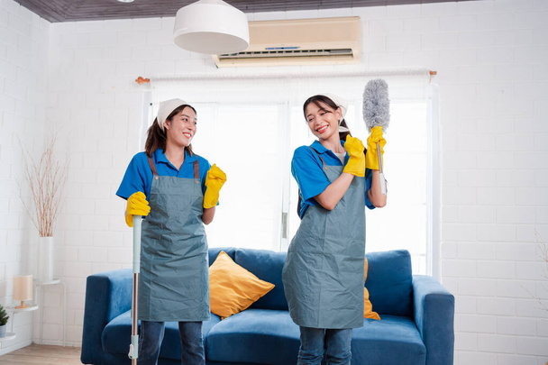 Housework or house keeping service two female cleaning dust in home, cleaning agency small business. professional equipment cleaning old home. - Zdjęcie, obraz