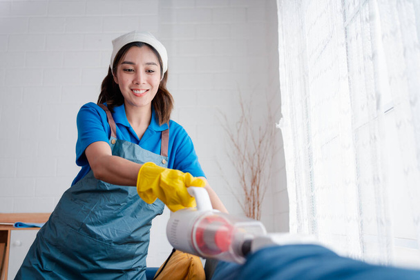 Housework or house keeping service female cleaning dust in home, cleaning agency small business. professional equipment cleaning old home. - Foto, Imagem