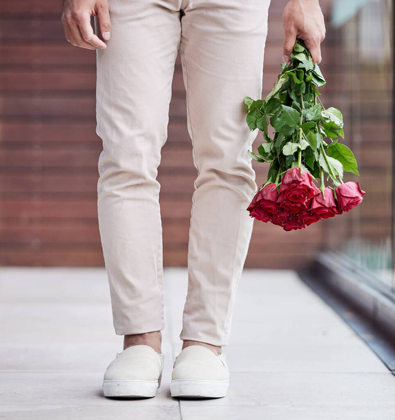 Love, legs and man with rose bouquet, romance and present giving hope for valentines day date. Romantic confession, floral gift and person holding flowers, standing outside for proposal or engagement. - Foto, Bild