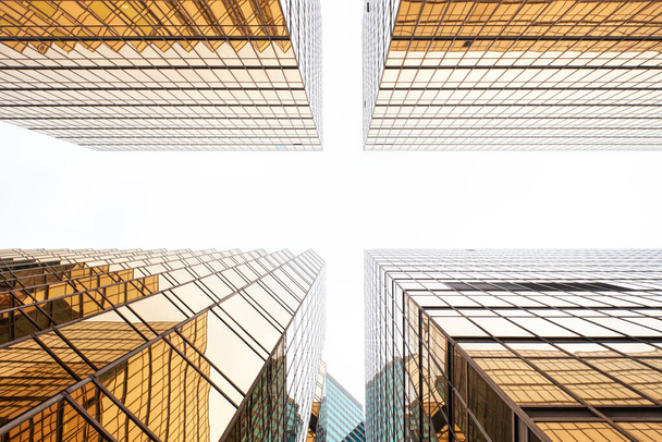 Hong Kong, China - April 28 2023: Symmetrical Golden Exterior facade Design of Office Buildings - Photo, Image