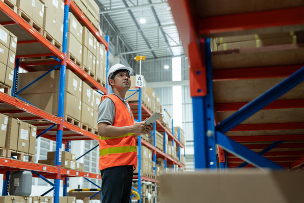 Asian male factory manager inspect goods in warehouse or inventory and check stock product. Transport logistic business shipping, delivery to customers. inspection, storehouse, storage, factory - Valokuva, kuva