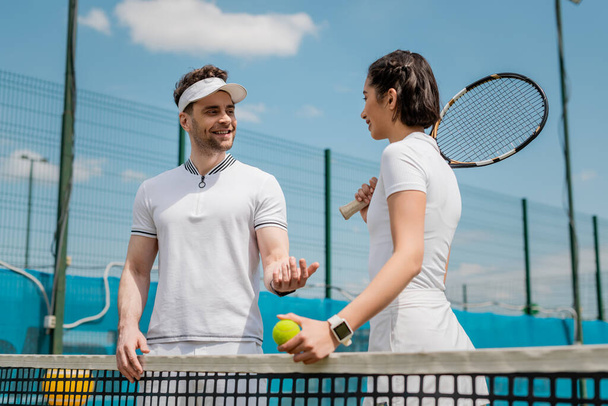 happy man and woman talking on tennis court, summer sport, couple leisure, outdoor fitness - Photo, Image