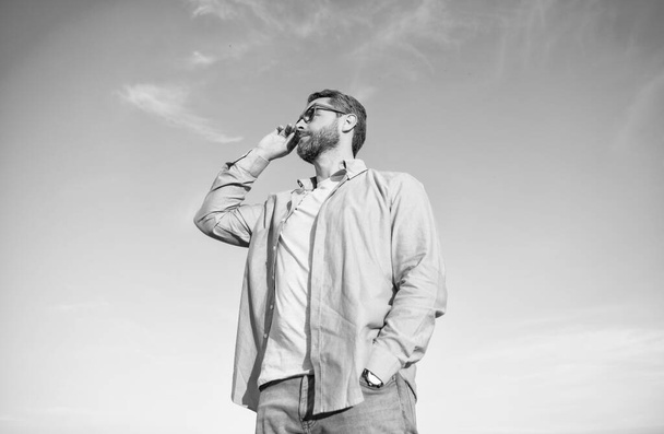 pensive caucasian man standing peaceful. pensive man in glasses outdoor. pensive man on sky background. - Фото, изображение