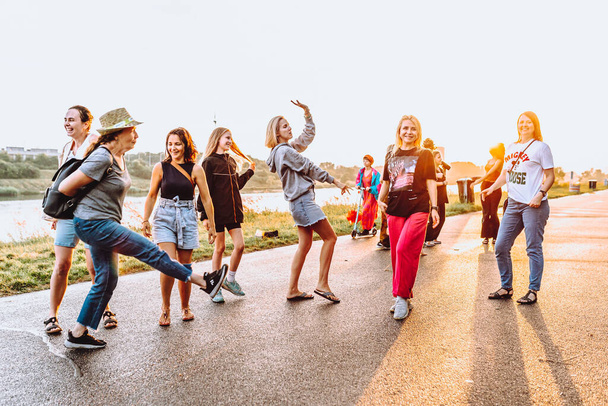 Party middle-aged women, millennials, at sunset. Group dancing cheerful attractive happy women, summer, vacation, travel. dancing cheerful attractive women at sunset.  - Fotó, kép