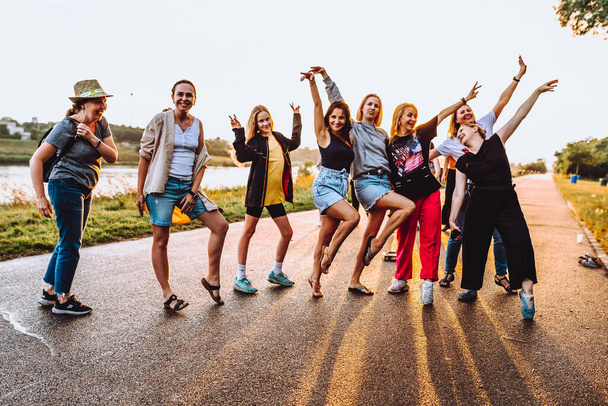 Party middle-aged women, millennials, at sunset. Group dancing cheerful attractive happy women, summer, vacation, travel. dancing cheerful attractive women at sunset.  - 写真・画像