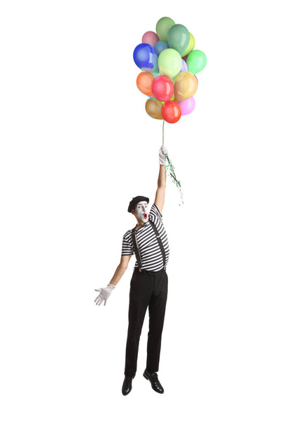 Mime flying and holding a bunch of balloons isolated on white background - Fotografie, Obrázek