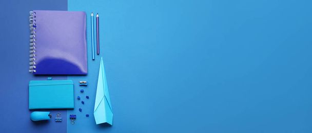 Paper plane with school supplies on blue background with space for text - Photo, Image