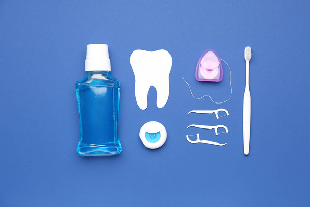 Set for oral hygiene and tooth model on blue background - Photo, Image
