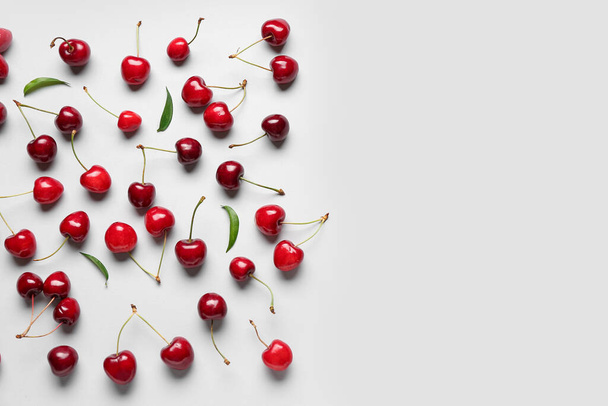 Many sweet cherries on grey background - 写真・画像