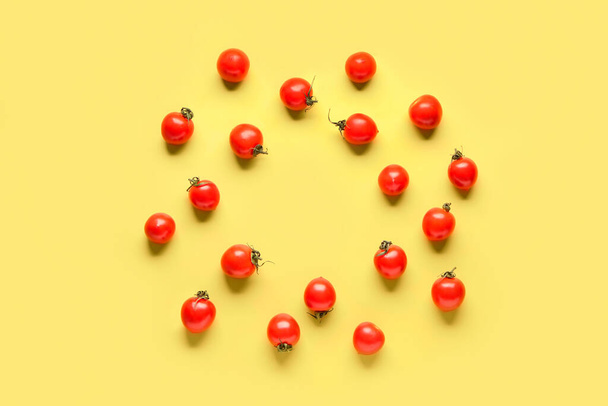 Frame made of fresh cherry tomatoes on yellow background - Photo, image