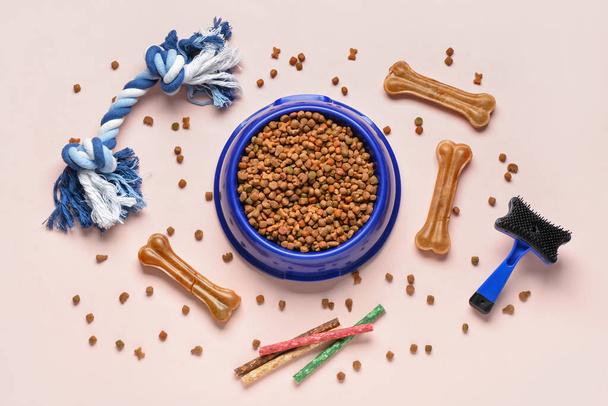 Composition with bowl of dog food and accessories on light background - Photo, Image