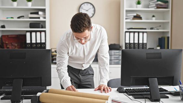 Young hispanic man architect drawing house plans at office - Photo, Image