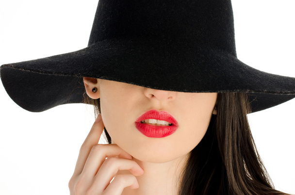 Woman with a big black hat covering her eyes. Beautiful perfect red lips, sexy mouth - Fotoğraf, Görsel