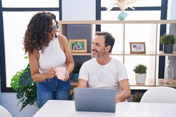Man and woman couple smiling confident using laptop at home - Foto, immagini