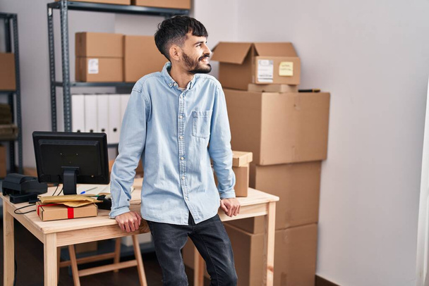 Young hispanic man ecommerce business worker smiling confident at office - Foto, Imagem