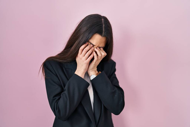 Young brunette woman wearing business style over pink background rubbing eyes for fatigue and headache, sleepy and tired expression. vision problem  - Фото, изображение