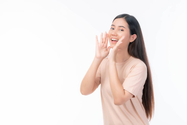beautiful Asian business young woman screams announce the good news or promotion , holding hands near her face with open mouth Herald news promotion on white background - Fotó, kép