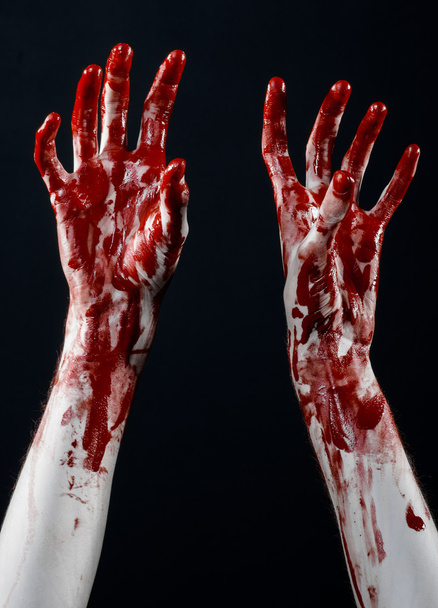 Bloody halloween theme: bloody hands killer zombie isolated on black background in studio - Zdjęcie, obraz