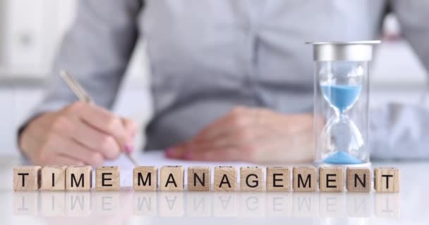 Wooden cubes written time management on the managers desk, close-up, shallow focus. Priority task, successful deadline - Felvétel, videó