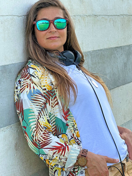 Blonde woman wearing stereo music headphones and sunglasses on music inspiration concept. - Фото, зображення