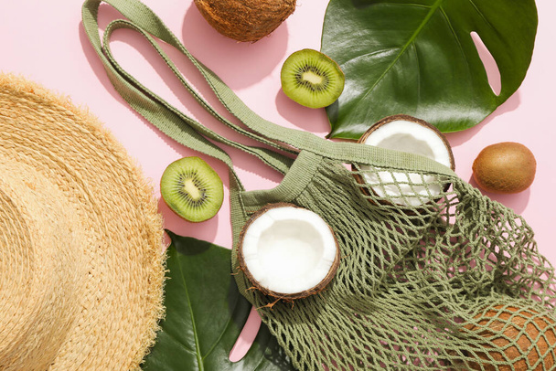 Top view, still life summer concept with coconut, kiwi, leaves and bag - Photo, image