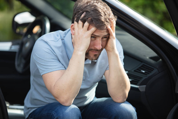 driver portrait feeling pain after car accident - Fotografie, Obrázek