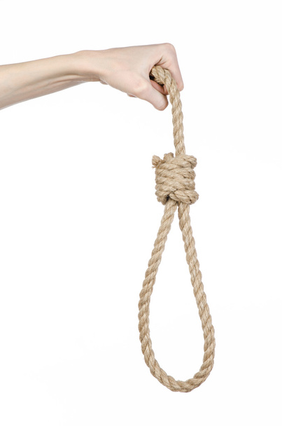 Lynching and suicide theme: man's hand holding a loop of rope for hanging on white isolated background - Foto, Bild
