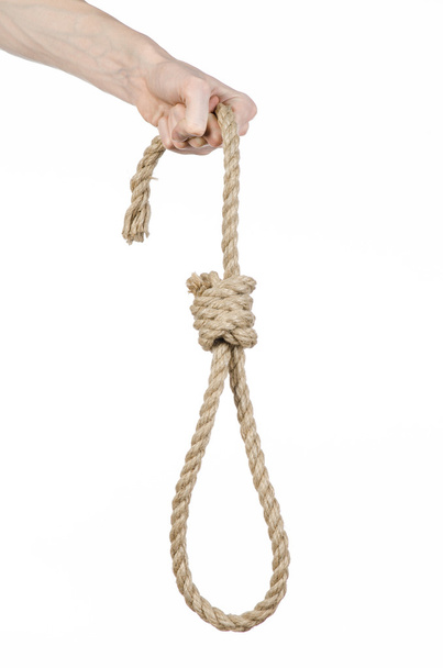Lynching and suicide theme: man's hand holding a loop of rope for hanging on white isolated background - Photo, Image
