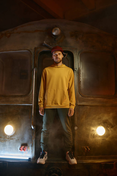 Breakdancer hipster b-boy standing at urban subway train. Contemporary freestyle dance performance concept - Fotografie, Obrázek