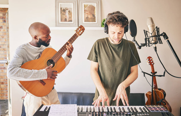 Music, piano and friends with guitar recording in home studio together. Electric keyboard, instrument and microphone of singer with teamwork, creative men and artists in production of acoustic sound. - Foto, Imagem