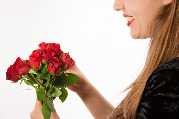 A young beautiful woman with red roses - Photo, Image