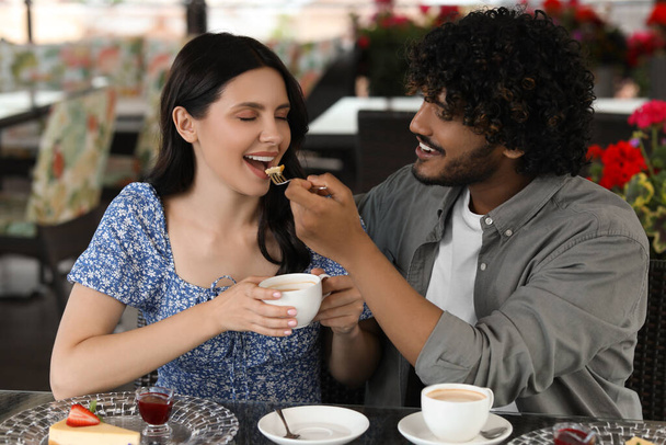 International dating. Happy couple spending time together in restaurant - Zdjęcie, obraz