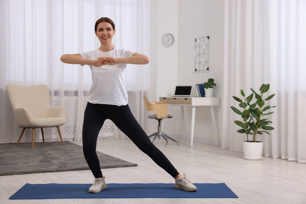 Happy woman doing morning exercise at home, space for text - Fotoğraf, Görsel