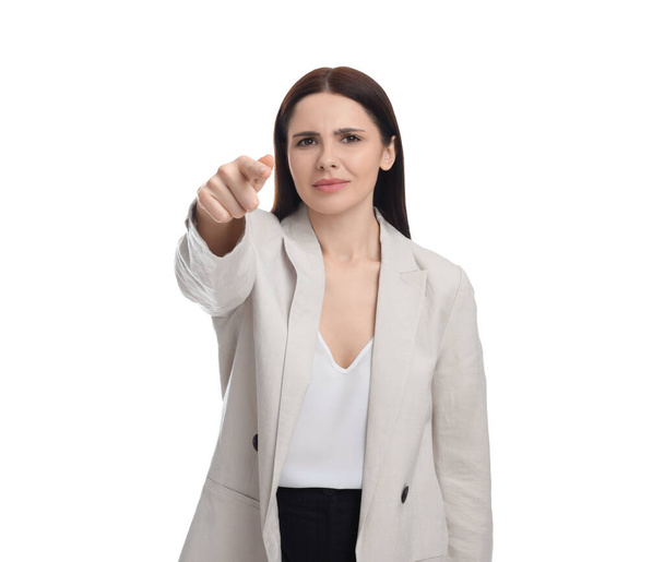 Beautiful businesswoman in suit pointing at something on white background - Foto, Imagen