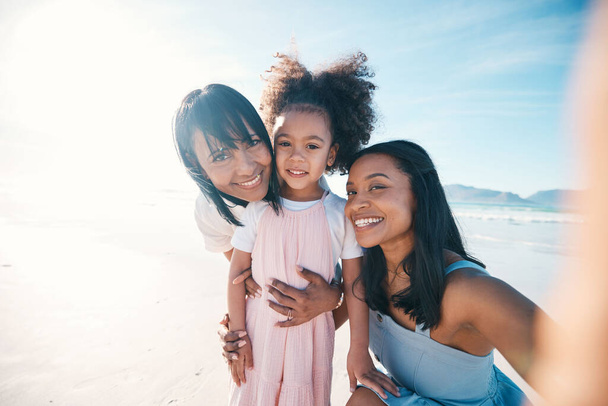 Selfie of mother, daughter and grandmother on the beach together during summer for vacation or bonding. Portrait, family or children and a little girl in nature with her parent and senior grandparent. - Photo, Image