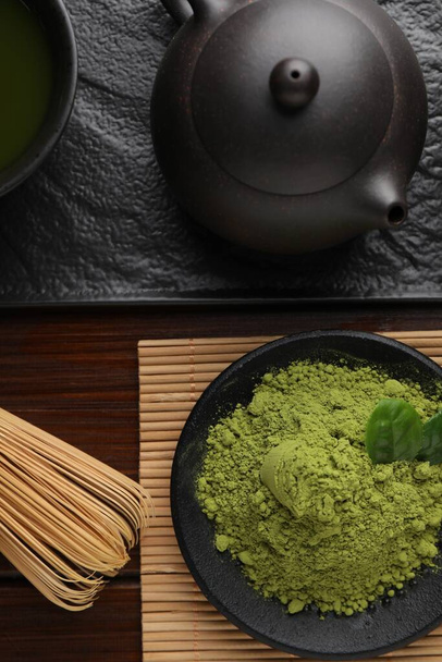 Flat lay composition with green matcha powder on wooden table - Photo, image