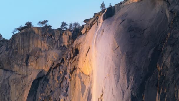 Panning view of wonderful Yosemite Firefall located in Yosemite National Park, California, USA. Breathtaking shot of Horsetail fall, occurs on the east side of El Capitan rock formation, 4k footage - Footage, Video