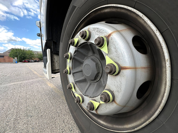 Truck wheel and tire and nuts indicators shows defects in tension nut - Photo, Image