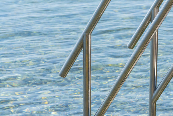 Opatija, Croatia. July 10, 2023. the steel handrail that descends into the sea - Foto, immagini