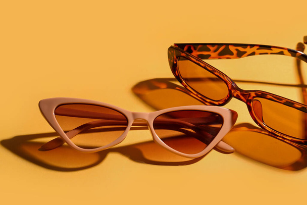 Stylish eyeglasses on yellow background, closeup - Fotoğraf, Görsel
