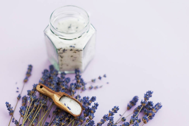 Lavender sugar on purple background, copy space. Bouquet of dry lavender and glass jar with lavender sugar - Photo, image