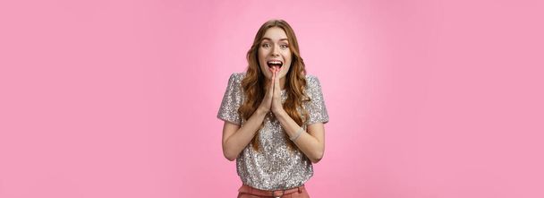 Excited attractive girlfriend eager start pack ready travel abroad win tickets press palms together happily thrilled looking amused feeling happiness standing pink background glamour outfit. - 写真・画像
