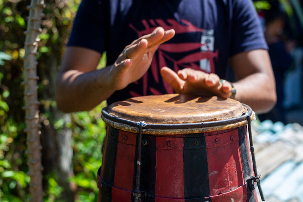 Braziliaanse atabaque wordt gespeeld door de handen van een muzikant. Gevoel van kracht en snelheid. Constant tempo. Acupe, Santo Amaro, Bahia. - Foto, afbeelding