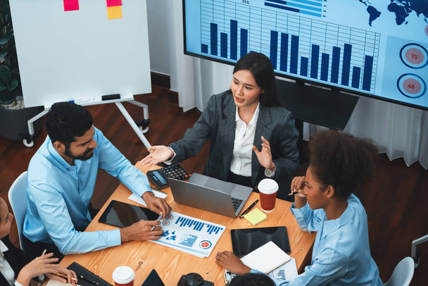 Top view multiracial analyst team use BI dashboard data to analyze financial report on meeting table. Group of diverse business people utilize data analysis by FIntech for business decision. Concord - Fotoğraf, Görsel