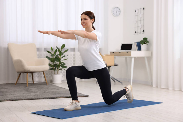 Happy woman doing morning exercise at home - Photo, Image