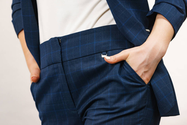 Business woman wearing suit holding hand in pants pocket. Detail view hips in trousers - Photo, image