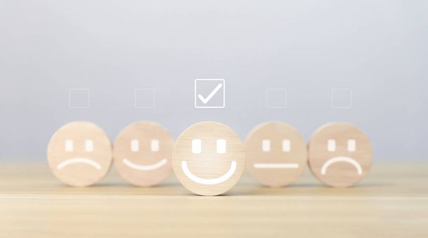 wooden block showing a smiley icon. customer concepts, satisfaction surveys, positive feedback The best response service from product user experience. - Photo, Image