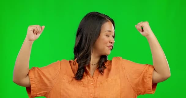 Face, woman and flex muscle on green screen in studio isolated on a background. Portrait, strong arms and Asian person with power, empowerment and pride for strength, gender equality and funny laugh - Footage, Video