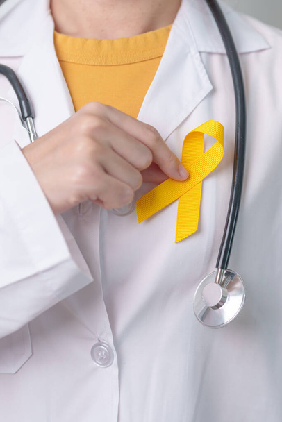 Yellow September, Suicide prevention day, Childhood, Sarcoma, bone and bladder cancer Awareness month, Yellow Ribbon for supporting people life and illness. Healthcare and World cancer day concept - 写真・画像