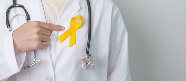 Yellow September, Suicide prevention day, Childhood, Sarcoma, bone and bladder cancer Awareness month, Yellow Ribbon for supporting people life and illness. Healthcare and World cancer day concept - Fotoğraf, Görsel